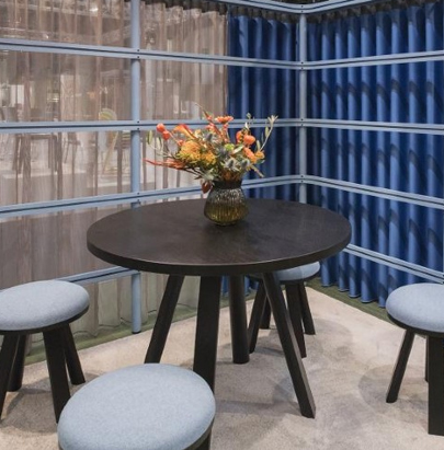 BuzziMilk Stool 2 in Grey Seat with Round Black Table With Overhead Lighting in Breakout Setting