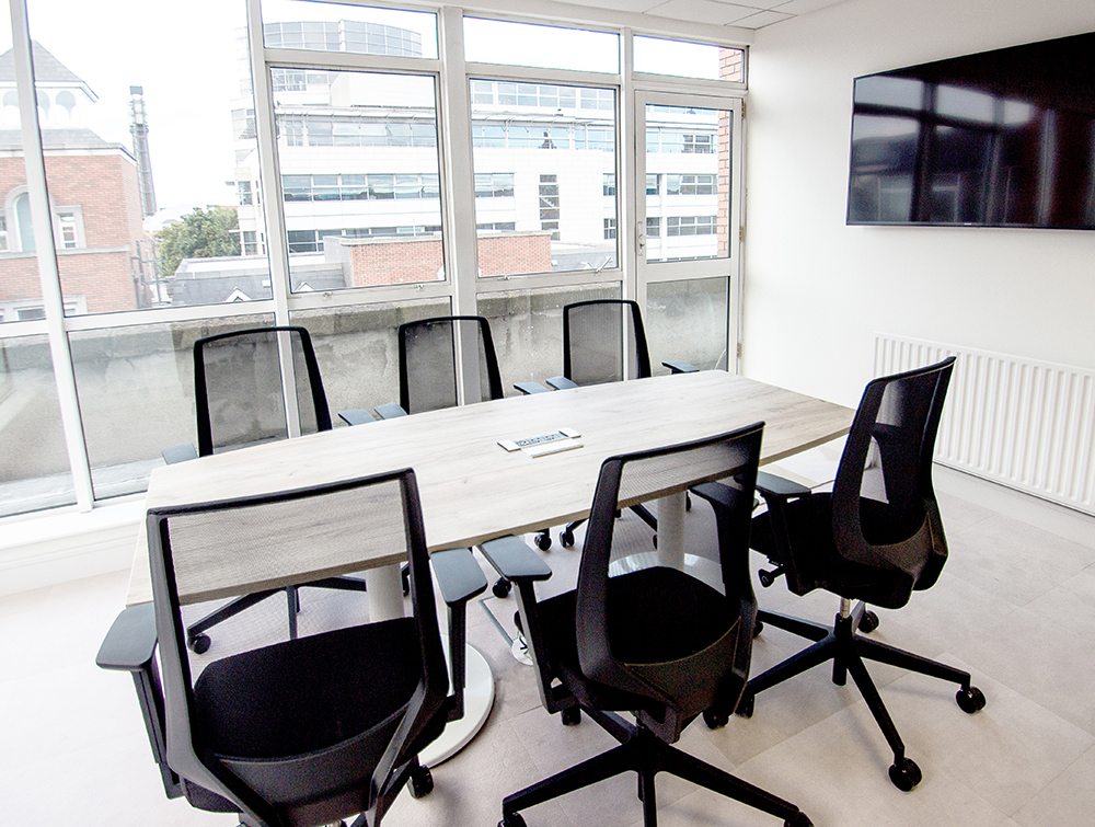 Conference Room with Mesh Chairs and TV Screen Embedded on Wall