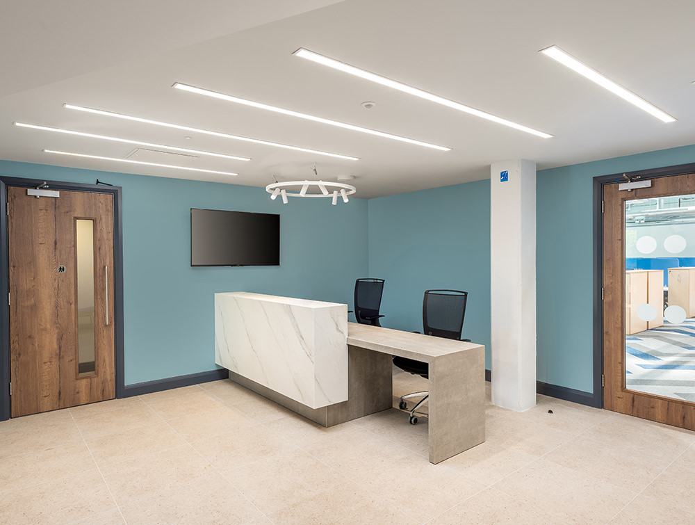 Precision Software Office Reception Desk with Overhead LED Lights and High Back Mesh Chairs