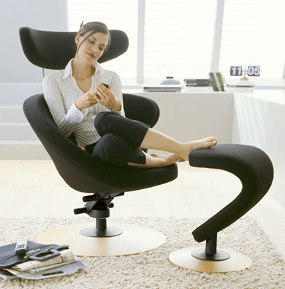 Varier Peel Chair in Black Fabric and Wooden Trumpet Base with Footrest in Home Setting